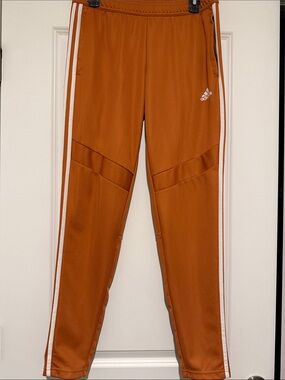 adidas women’s Rust-Orange Jogger Pants with White Stripes
